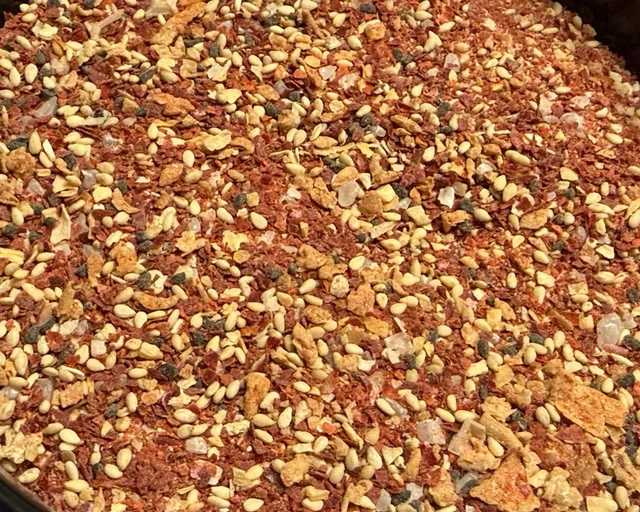 Close-up of the Fire Dust blend with red chili flakes and sesame seeds