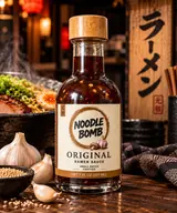 NoodleBomb Original ramen sauce with a bowl of ramen, garlic and sesame